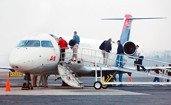 Passengers board Atlantic Southeast Airlines plane